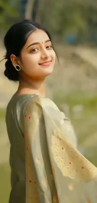 Woman in traditional attire smiling amidst nature.