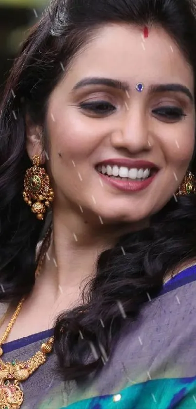 Smiling woman in colorful saree with elegant jewelry.