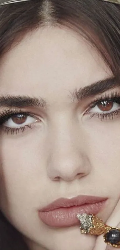 Elegant woman with crown and ring in a close-up portrait.