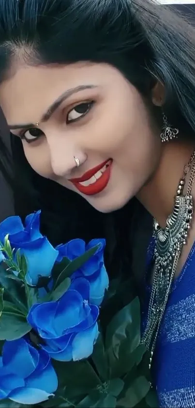 Smiling woman holding blue roses, wearing silver jewelry.