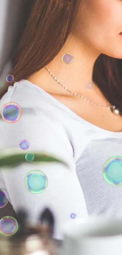 Woman in white with colorful floating bubbles and serene expression.