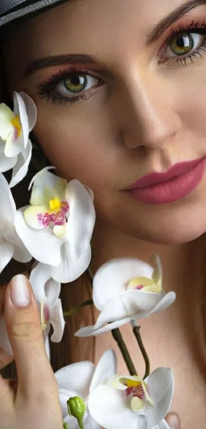 Portrait of a woman with orchids against a soft pink background.