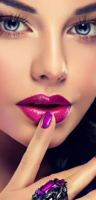 Woman with purple lipstick and nails in elegant style.