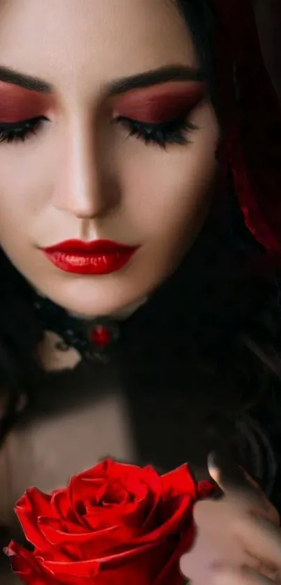 Elegant woman in red makeup holding a red rose, on a dark background.