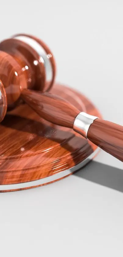 Elegant wooden gavel on a smooth surface.