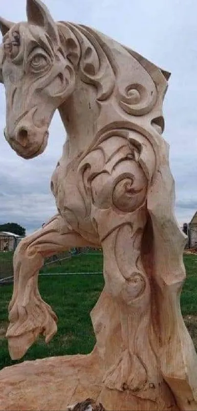 Intricate wooden horse sculpture stands in outdoor setting.