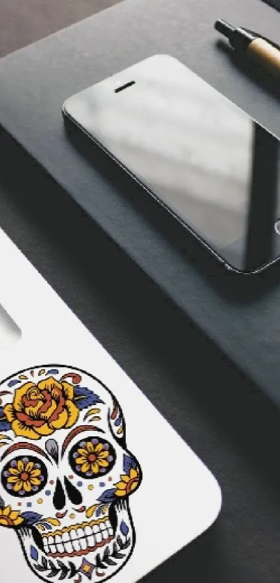 Elegant workspace with smartphone, notebook, and laptop with skull sticker.