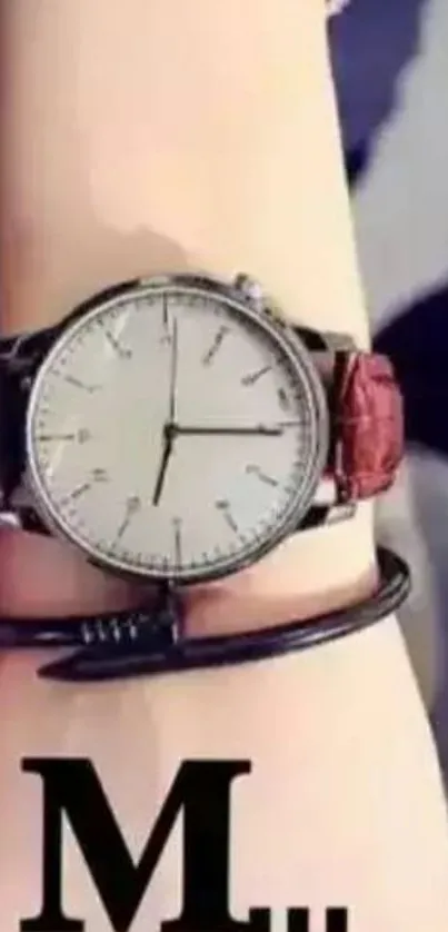 Elegant wristwatch with leather strap on arm.