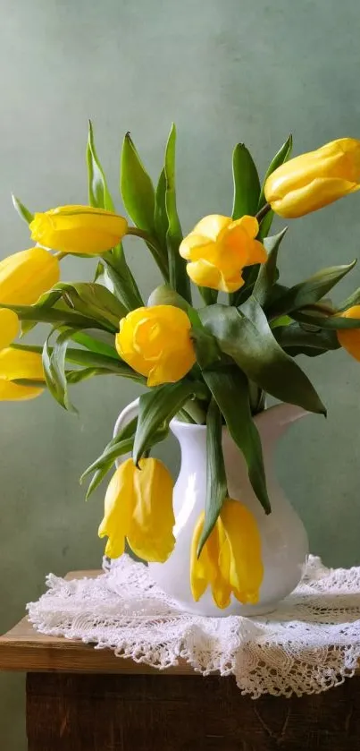 Yellow tulips in a white vase against a green wall.