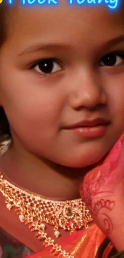 Portrait of a young girl in traditional attire with jewelry and henna.