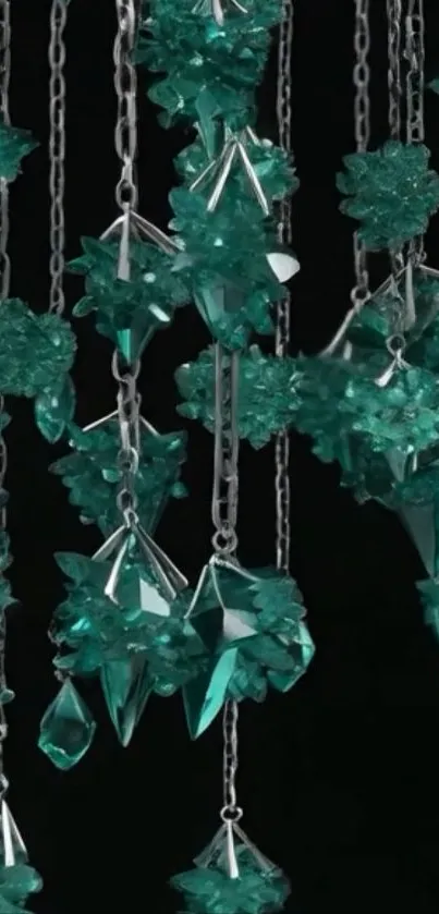 Emerald crystals hanging from chains, dark background wallpaper.