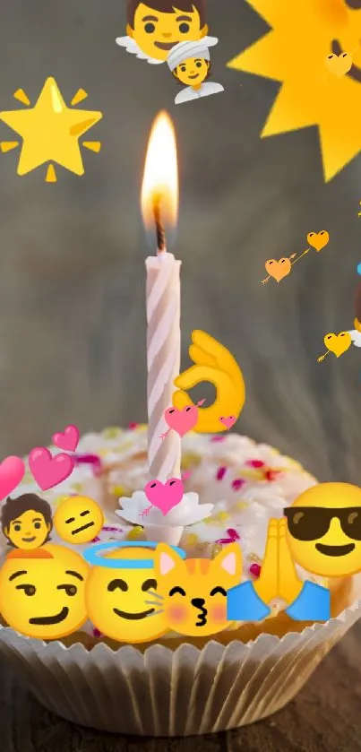Cupcake with emojis and candle on wooden table.