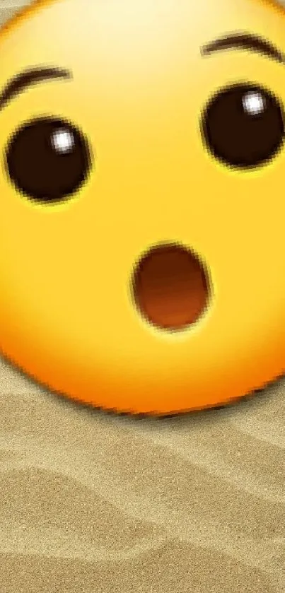 Surprised emoji on a sandy beach background wallpaper.