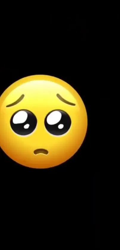 Sad emoji on a black phone wallpaper.