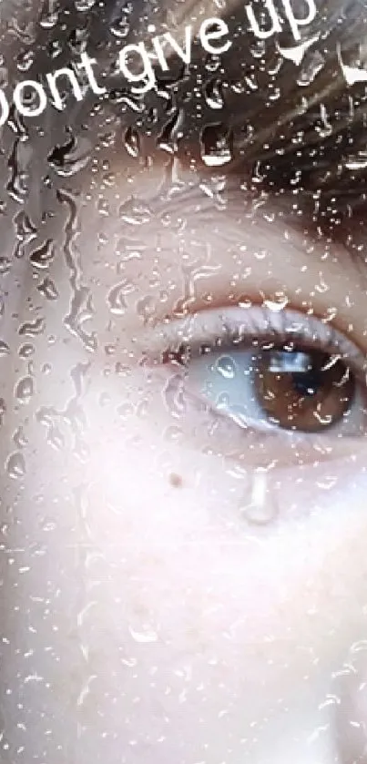 Close-up of an eye with a teardrop, featuring the words 'Don't give up'.