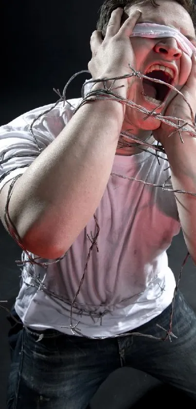 Blindfolded man in barbed wire with dark background.