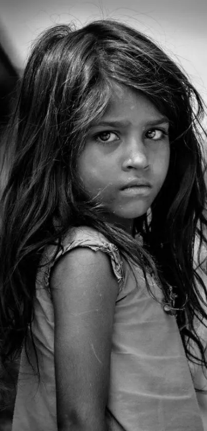 Black and white portrait of a young girl with expressive eyes.