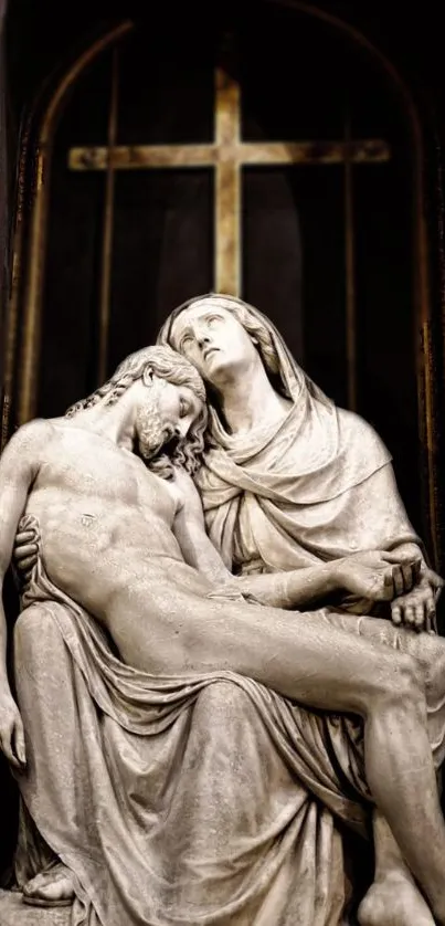 Marble sculpture of two figures with cross in background.