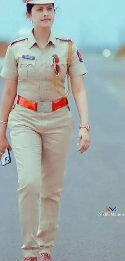 Police officer walking confidently on a road in uniform.