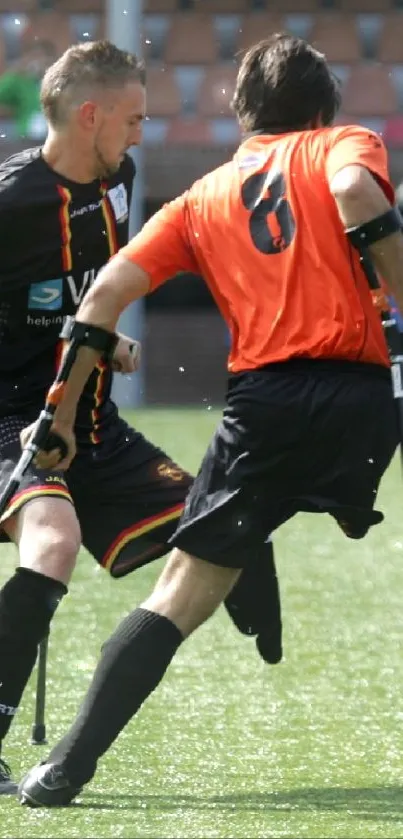 Amputee football players in action on a vibrant green field.