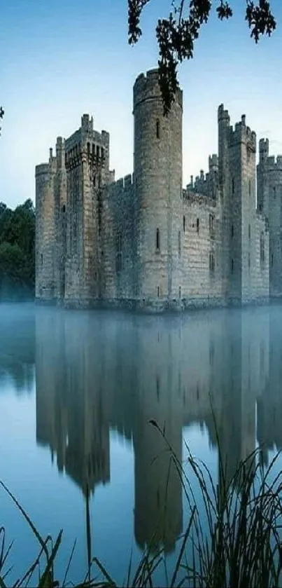 Serene castle reflection on a misty lake with surrounding trees.