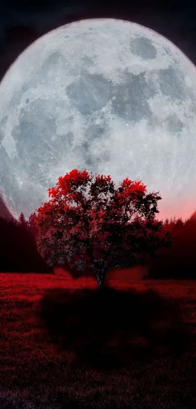 Mysterious full moon over a red tree at night.