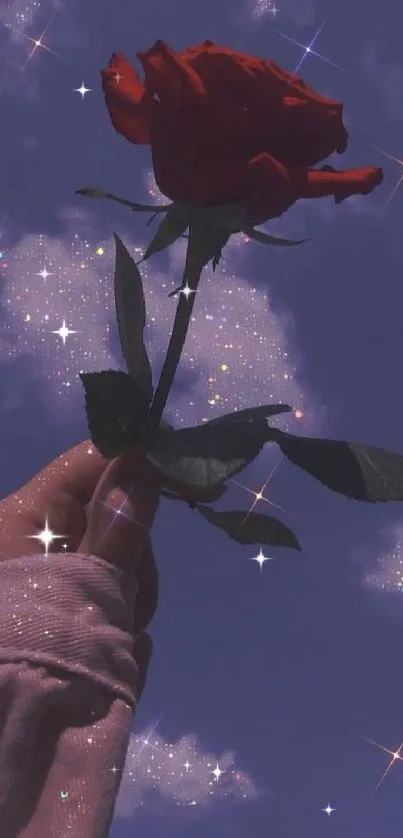 A hand holds a red rose against a starry, midnight blue sky.