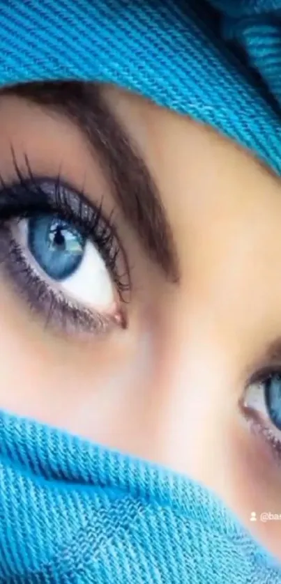 Close-up shot of captivating blue eyes wrapped in a blue fabric.