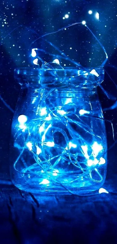 Glass jar with glowing blue fairy lights on dark background.