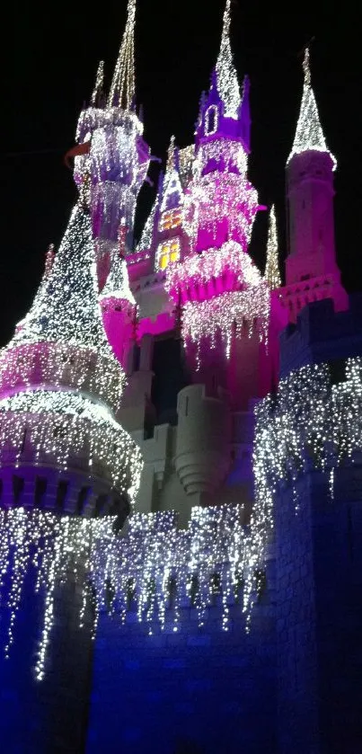 Illuminated castle with purple lights against a night sky.