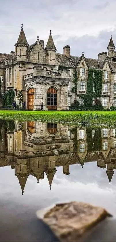 Majestic castle reflected in tranquil water landscape.