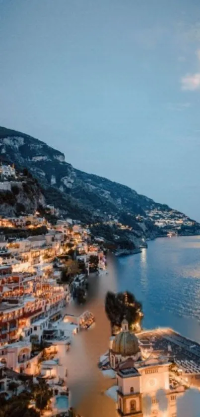 Coastal cityscape with lights at dusk overlooking serene waters.