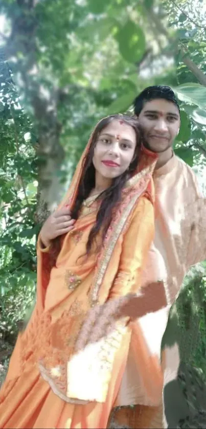 Couple in traditional attire amidst lush forest backdrop.