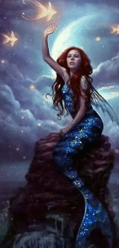 Mermaid on rock under moonlit night sky.