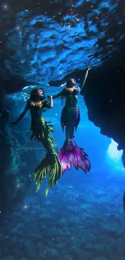 Two mermaids exploring a mystical underwater cave with vibrant tails.