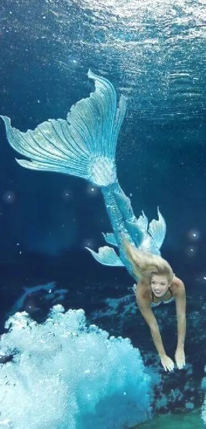 Enchanting mermaid swimming underwater in ocean depths.