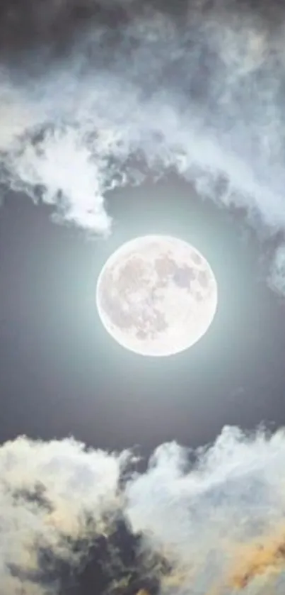 Full moon surrounded by glowing clouds at night.