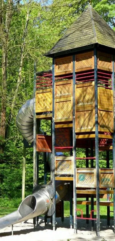 Tall wooden playground slide tower amidst lush greenery.