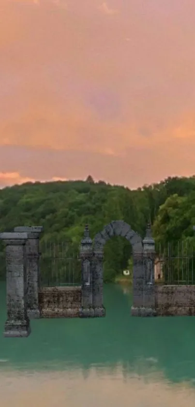 Stone gate over a lake at peach sunset.