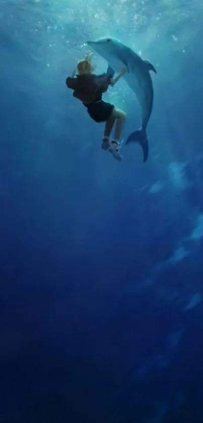 A diver embraces a dolphin underwater in deep blue sea.