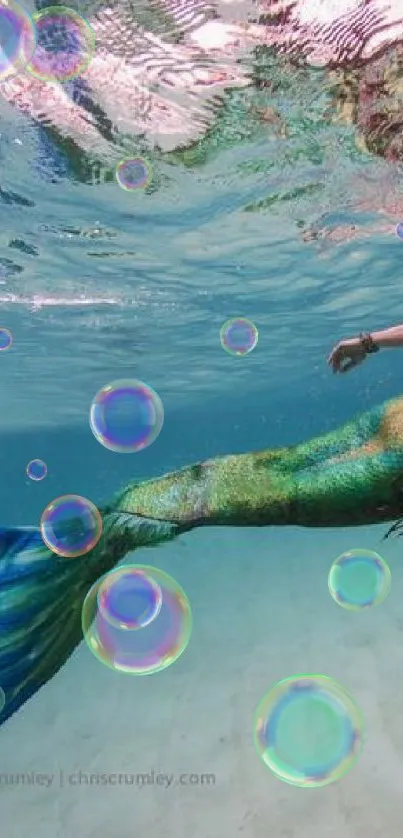 Underwater view of a mermaid swimming gracefully in the ocean.