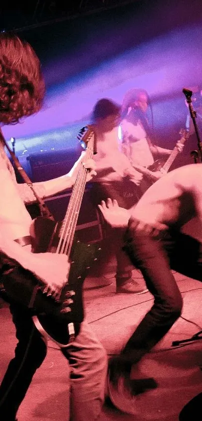 Energetic rock band performing live on stage with vibrant purple lighting.