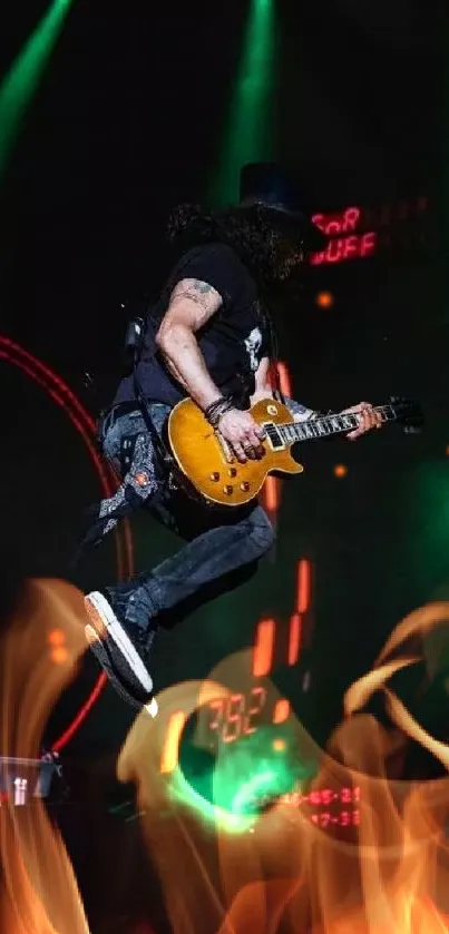 Guitarist jumping on stage during a live concert with vibrant green lights.