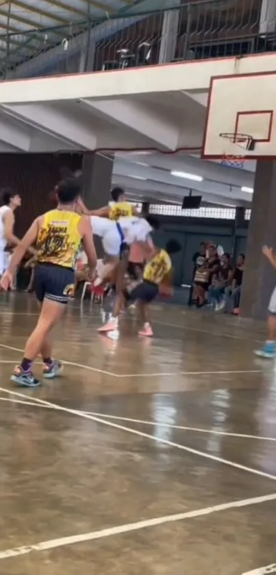 Players in energetic basketball game on indoor court.