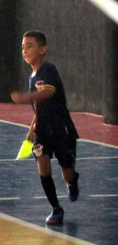 A child energetically playing indoor soccer on a vibrant court.
