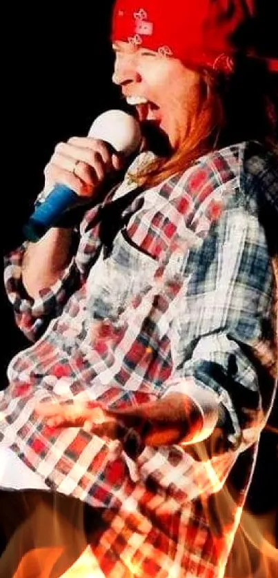 Energetic performer in red bandana and plaid shirt on stage.