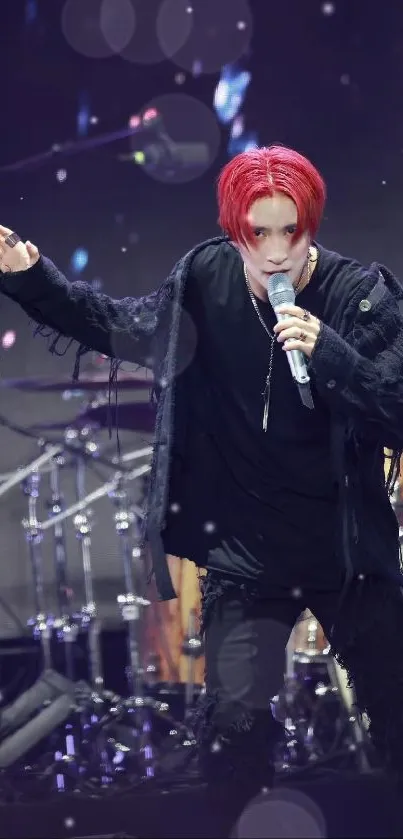 Energetic rock performer on stage with bright red hair and dynamic lighting.