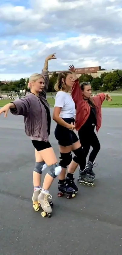 Three women roller skating energetically on a park road.