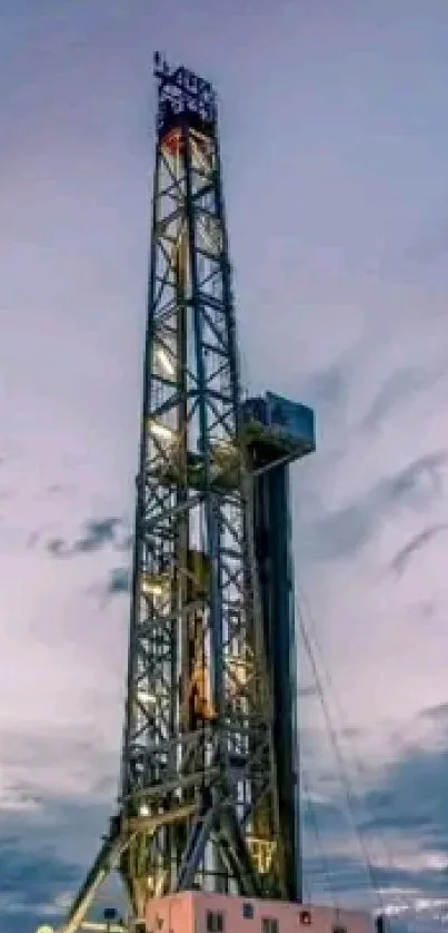 Split image of an oil rig and wind turbines under a blue sky.