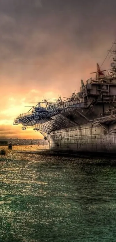 Battleship at sunset on calm waters, showcasing a dramatic sky.